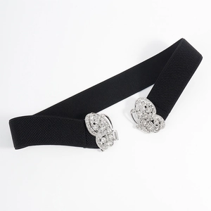 Elastic black waist belt with a sparkling silver rhinestone butterfly buckle on white background