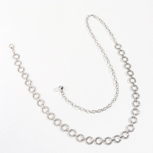 Detail of silver geometric ring belt featuring adjustable chain and solid metal bead