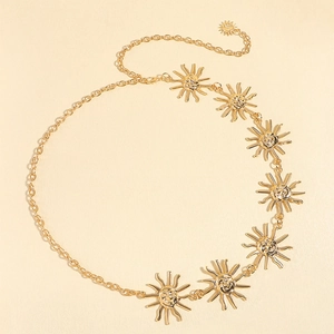 Macro view of gold sunburst medallion chain belt with detailed sun god relief charms