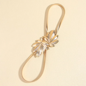 Elegant gold metal spring waist belt featuring dual maple leaf buckle for dresses