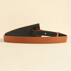 Détail de ceinture en cuir caramel avec rabat triangulaire et surpiqûres précises