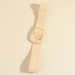 Detailed close-up of khaki woven elastic belt featuring a round fabric wrapped buckle