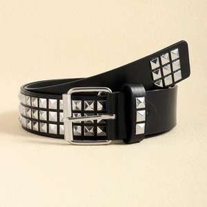 Detail shot of black punk belt with three rows of silver square rivets and metal buckle