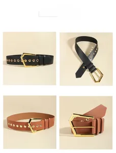 Close-up of geometric gold hexagonal buckle and studded leather belt texture details