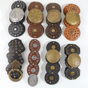 Close-up of Western style leather belt buckles with Baroque embossed metal patterns