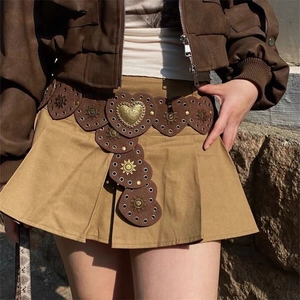 Close-up of Western style dark brown belt with heart modules and vintage metal sunflower studs
