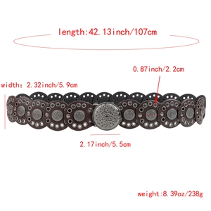 Close-up of vintage Bohemian wide leather belt with silver studs and carved buckle