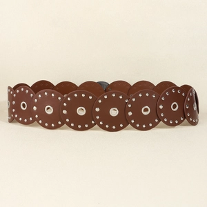 Detail of western retro waist belt with brown overlapping leather discs and metal rivets