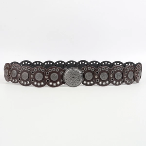 Detail of bohemian leather belt with metal eyelets and a vintage mandala buckle