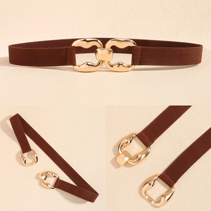 Close-up of brown elastic waist belt with curved gold geometric buckle for dresses