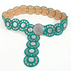Detailed view of bohemian turquoise rivet belt with ornate metallic round buckle
