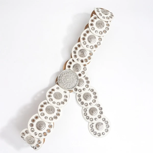 Detailed view of bohemian belt featuring white round discs and silver floral metal plates