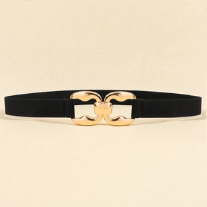 Detailed macro view of black elastic belt with polished gold interlocking metal buckle