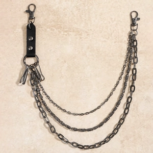 Macro view of triple-layered dark gray punk metal wallet chains with leather rivet accents