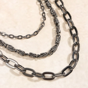 Close-up of three styles of punk black metal pant chains with various link designs