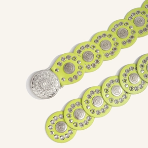 Detail of neon green bohemian belt with silver floral mandala metal buckle and eyelets