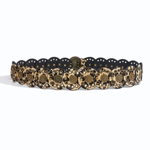 Detail of bohemian wide belt featuring leopard print discs and bronze floral metal relief