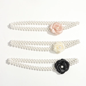 Detail of camellia pearl chain belts in pink, cream and black for elegant dress styling