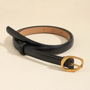Detailed close-up of a slim black leather belt featuring an oval matte gold metal buckle