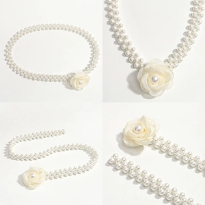 Detail of three-row pearl waist chain featuring a delicate white camellia flower ornament