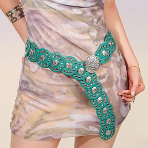 Detail of bohemian turquoise leather waist belt with vintage silver metal relief discs