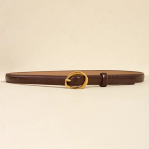 Detailed view of women's dark brown leather belt with matte gold asymmetrical metal buckle