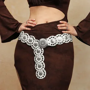 Detail of vintage white leather waist belt with embossed silver metal disks on model