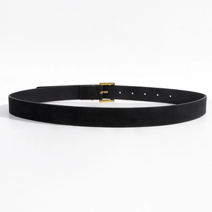 Detail of the black leather belt featuring a classic gold square metal buckle and adjustment holes
