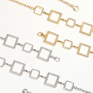 Golden and silver metal chain belt with square frame links and textured geometric design
