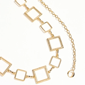 Detail of vintage golden square hollow metal waist chain with embossed relief texture