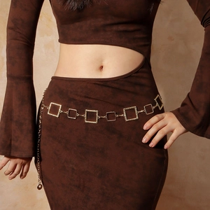 Close-up of golden geometric square link waist chain on a knit dress with adjustable clasp