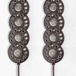 Detail of ethnic dark brown PU leather waist belt with antique silver floral metal buckles