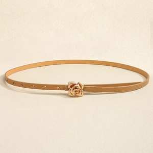 Close-up of camel leather skinny belt with a 3D golden rose buckle and adjustable holes