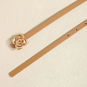 Detail of thin camel leather belt featuring a gold 3D rose buckle and adjustment holes