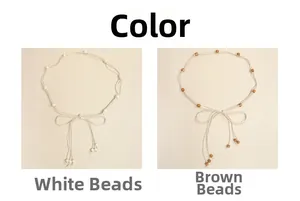 Detail of bohemian hand-woven waist ropes with white and brown decorative beads