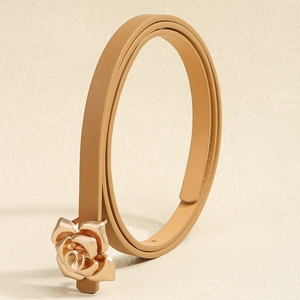 Close-up of elegant gold rose-shaped buckle on a slim khaki leather belt