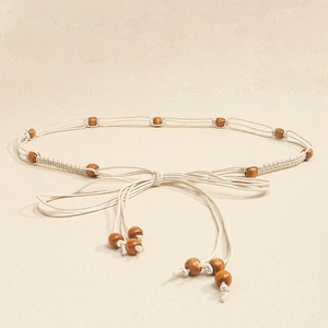 Detail of bohemian braided waist chain with natural cotton rope and wooden beads