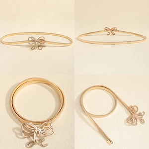 Detailansichten des goldenen Federgürtels mit eleganter Schleifenschnalle für Kleider