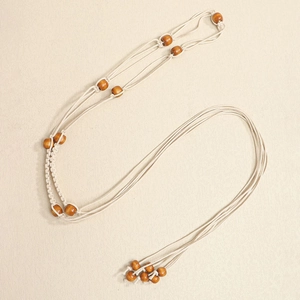 Detail of bohemian woven rope belt with wooden beads and handmade macrame fringes