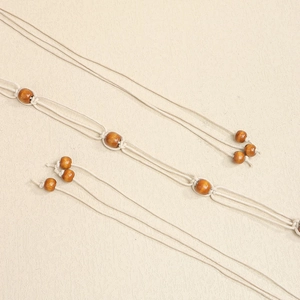 Detailed macro view of bohemian braided cotton rope with natural wood bead accents