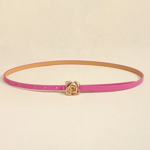 Detail of elegant pink slim leather belt featuring a golden rose-shaped metal buckle