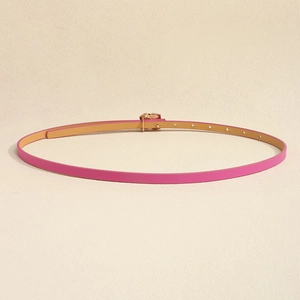 Detail of rose pink leather belt with gold buckle and adjustable holes for dresses