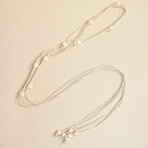 Detail view of Bohemian woven cotton rope with natural wooden beads for styling