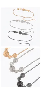 Detail of metal waist chain featuring sun relief discs in gold silver and gun grey finishes