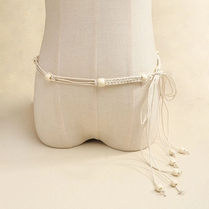 Bohemian braided waist chain with beige ropes and wooden beads shown on a mannequin