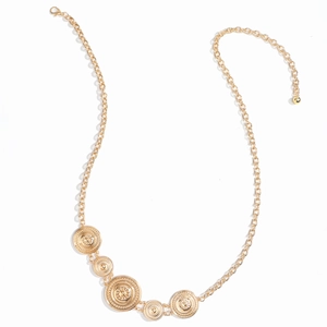 Detailed close-up of gold chain belt featuring vintage sunburst embossed round pendants