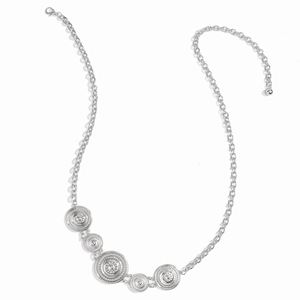 Detailed view of silver metal waist chain with sun pattern discs and lobster clasp closure