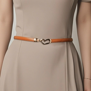 Caramel brown slim leather belt with gold heart buckle on a dress for styling