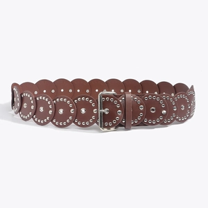 Detail of brown leather belt with layered circular patches and silver metal rivets