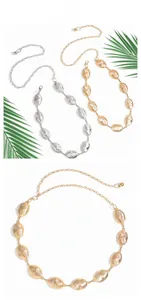 Close-up of gold and silver oval chain belts featuring brushed metal texture and lobster clasp